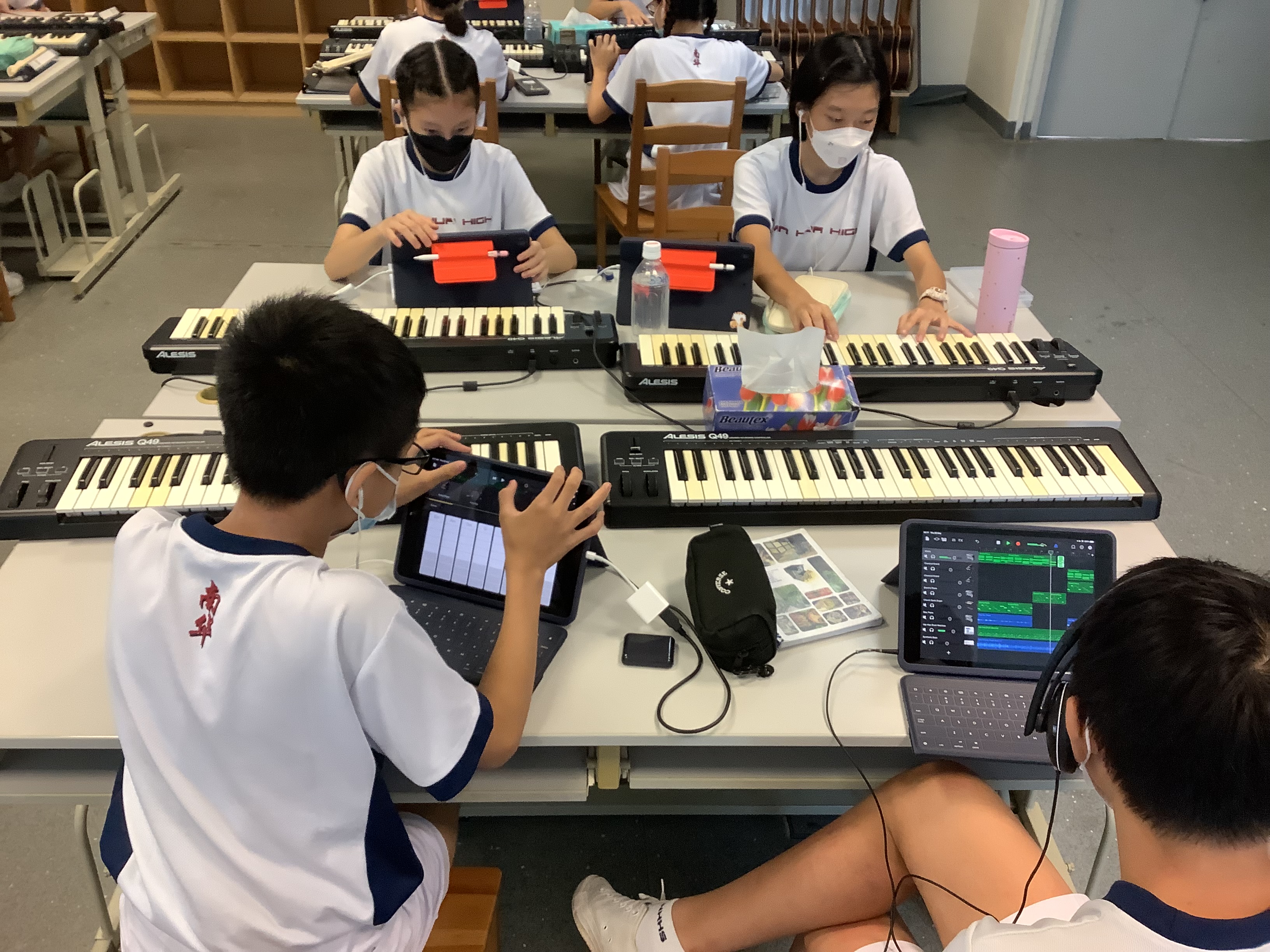 Secondary 1 students creating music using GarageBand