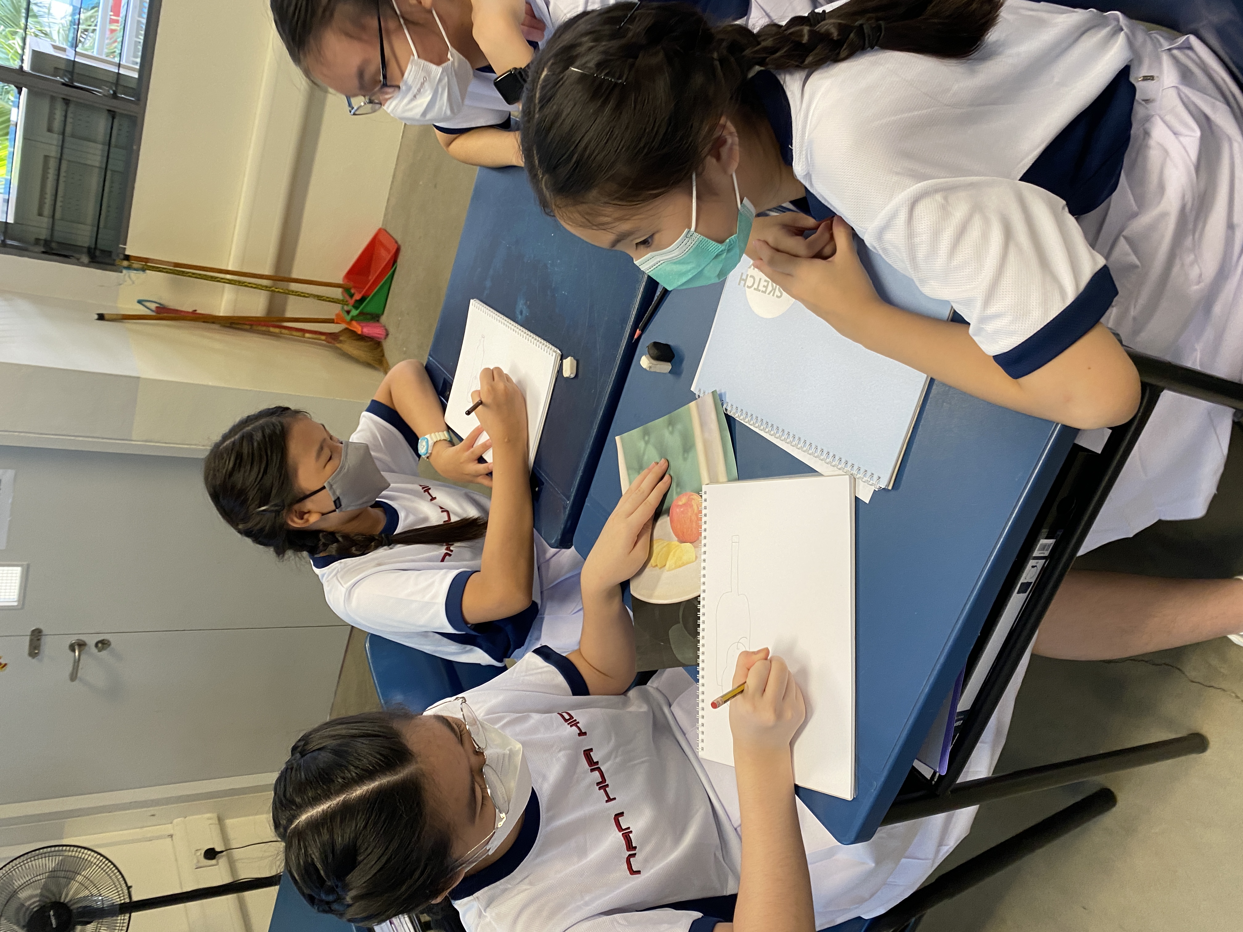 Secondary 1 students drawing based on verbal descriptions in pair-work activity