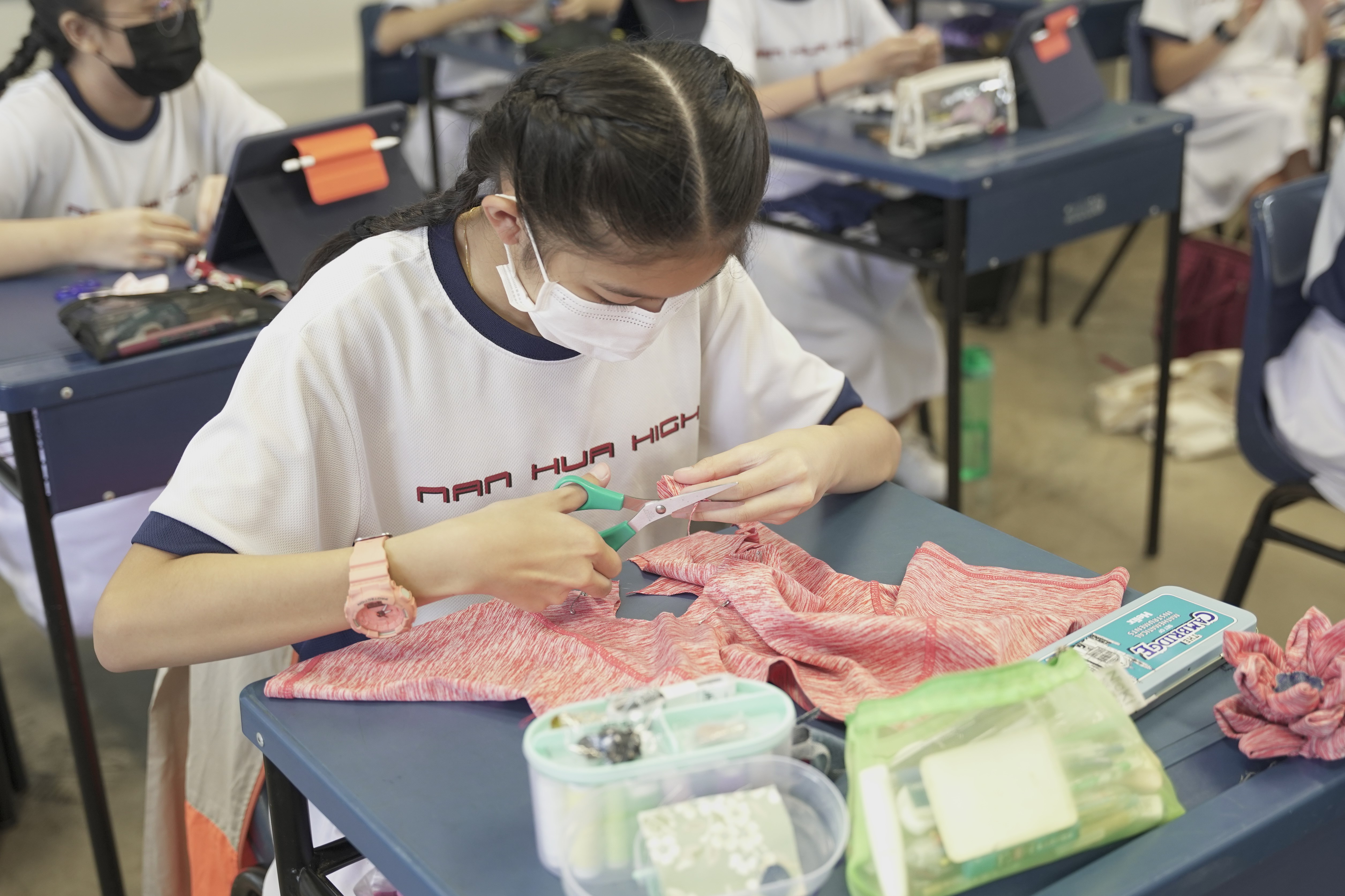 Secondary 2 student creating fabric flowers during AAA FCE module